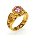 Close-up of vintage golden men's ring with a central pink gemstone and ornate carvings - Size 7 / Gold (Pink Rhinestone)