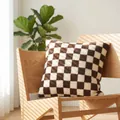 Soft brown and white checkerboard sherpa pillow cover on a wooden chair - 45x45 with 400g Core / Coffee