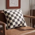 Premium grey and white checkerboard lamb wool cushion cover on a wooden armchair - 45x45 with 400g Core / Gray