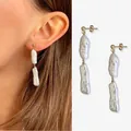 Elegante oorbellen met natuurlijke barokparels en een luxueuze 18-karaats goudvergulding. - Eén maat / Lange oorbellen met twee parels