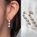 Elegante drievoudige zoetwaterparel oorbellen met 18K vergulde titanium stalen haken - Eén maat / Pareloorbellen met gouden tussenstukjes