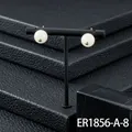 Elegant white round stone stud earrings with gold-plated base on professional display. - Green Jade Stud