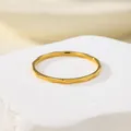 Detailed macro view of a minimalist gold water-ripple textured thin ring for women - US 5 / Gold