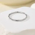 Macro detail view of a thin titanium steel ring with a faceted water ripple design - US 5 / Steel
