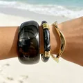 Stylish chunky acrylic bangle and gold wavy bracelet stack set against a beach background - Acrylic Texture and Gold Wave 3-Piece Set (32808)