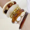 Exaggerated acrylic chunky bangle set featuring amber and cream stackable bracelets - Amber/Creamy White Spliced Multi-Layer Set (32892)