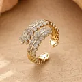 Elegant gold-finished leaf ring with sparkling pavé crystals and adjustable band - Feather Leaf Open Ring / Gold
