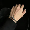 Punk style silver chain bracelet featuring a black stone and cross star charm on wrist - Punk Black Gemstone Star Cross Bracelet (5687)
