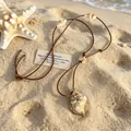 Bohemian shell pendant necklace with brown PU leather cord on beach sand background - 02 Conch Pendant (S411)