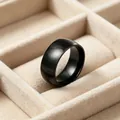 Macro detail of a sleek 8mm black stainless steel arc ring in a velvet display tray. - Size 7 / Curved Polished Plain Ring / Black