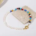 Macro view of handmade evil eye beaded necklace with pearls on a textured stone - Style I / One Size / 43cm (bp7-8)
