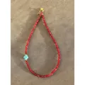 Close-up detail showing the faceted red beads and the turquoise stone on the necklace - Style J / One Size / 38+5cm / Red