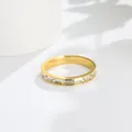 Close-up of minimalist gold stainless steel ring with half eternity cubic zirconia stones - US 5 / Gold (B201)