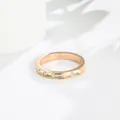 Close-up detail of an elegant rose gold stainless steel ring with baguette crystals - US 5 / Rose Gold (B201)
