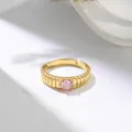 Close-up of titanium steel ring with pink gemstone and vertical ribbed texture - US 7 / Gold Pink Rhinestone
