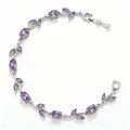 Detailed shot of silver bracelet with leaf motifs and purple crystal accents on white texture - Silver Purple Zirconia Tulip
