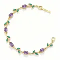Detailed macro shot of elegant gold vine bracelet with purple and green floral crystals. - Gold Purple Green Zirconia Tulip