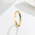 Detail view of a gold titanium steel ring with three inlaid black sparkling stones - US 7 / Black Zirconia (A250) - Gold