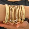 Detailed view of ten-piece gold-toned alloy bangle set with varied textures and rhinestones - 11 Pieces Collection (A-515)