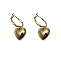 Close-up macro detail showing the polished finish of elegant gold heart hoop earrings - 3D Heart Pendant Style (XJE0014)