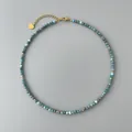 Vista dettagliata di una collana di perline in pietra naturale blu con ciondolo a cuore oro. - Stile fine blu-verde (14)