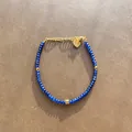 Detailed view of deep blue faceted natural stone beaded bracelet featuring a gold heart charm - Dark Blue Faceted Beads with Heart Pendant (Bracelet 3) / 17+3cm