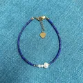 Close-up detail of blue natural stone beaded bracelet with pearl and gold heart charm - Blue Tubular Beaded Style with Artificial Pearl (Bracelet 14) / 17+3cm