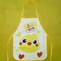 Close-up detail of yellow cartoon chicken waterproof apron for children's art painting. - Chick Pattern (4853638944411) / Yellow