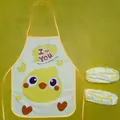 Close-up detail of cartoon chick waterproof child apron set with matching oversleeves - Chick Apron and Sleeve Set / Yellow