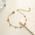 Eleganter goldener Armband mit hohlen vierblättrigen Kleeblatt-Anhängern und Kristallen - Armband (SL5095J)