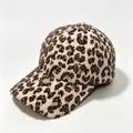 Detailed texture of a leopard print plush warm baseball cap with M metal logo - Coffee
