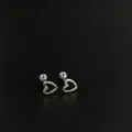 Exquisite close-up detail of silver stainless steel hollow heart-shaped ear bone studs - Hollow Heart / 1 Piece / Steel