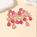 Long pink jelly faux gemstone tassel earrings with gold trim on warm background - Rose Red Gold