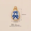 Ovaler vergoldeter Edelstahl-Anhänger mit blauen Emaille-Schleifen für Schmuck-DIY - Blauer Schleifenanhänger