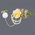 Elegant wedding bridesmaid wrist corsage featuring yellow roses and delicate pearl chains - Yellow Flower Luxury Hand Chains