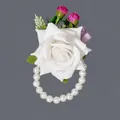 Elegant white rose wrist corsage for bridesmaids with pearl bracelet and pink buds - White Artificial Flower Photoshoot Bracelets