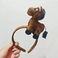 Close-up view showing the cute brown plush horse detail on the creative headband. - Brown Horse