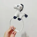 Close-up view of cute plush white horse animal headband for kids and adult performance - White Horse