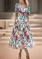 Detailed view of an elegant floral print maxi dress featuring a V-neck and short puff sleeves. - S / Green (Abstract Floral)