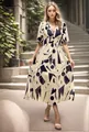 Elegant cream V-neck maxi dress with bold black geometric prints on a blonde model - Apricot (Geometric Pattern)