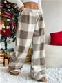 Cozy brown and white checkered fuzzy lounge pants shown in a festive holiday setting - S / Bottoms / Khaki Plaid