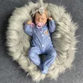 19 inch lifelike reborn baby doll Loulou wearing blue polka dot pajamas and bow headband - Blue Polka Dot Clothing / Full Vinyl Body
