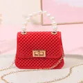 Trendy mini red jelly handbag featuring a pearl top handle and gold chain strap. - Red