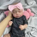 19 inch lifelike Loulou reborn baby doll featuring 3D skin and pink bow headband - Black White Polka Dot / Full Vinyl Body