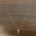 Detail view of silver-toned cross pendant necklace with sparkling cubic zirconia stones - Cross Silver