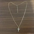 Detailed view of a gold stainless steel necklace with a sparkling cubic zirconia cross - Cross Gold