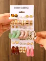 Detailed view of mixed resin and gold-tone earring set on a white display card. - 17-Card 3-Piece Set