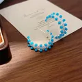 Detailed macro view of retro C-shaped earrings featuring blue turquoise beads and crystals - Blue Turquoise C-Shape Hoop Style (E2800) / Silver
