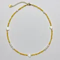 Detailed macro view of handmade yellow beaded necklace with white shell heart charms - Three Heart Shell and Artificial Pearl Necklace / 38+5cm