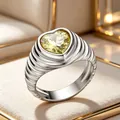 Detailed view of silver heart ring with faceted yellow gemstone and textured band - Size 6 / Steel + Green Zirconia